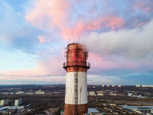 aerial-drone-view-thermal-station-sunset-with-smoke-coming-out-tube_1268-16964